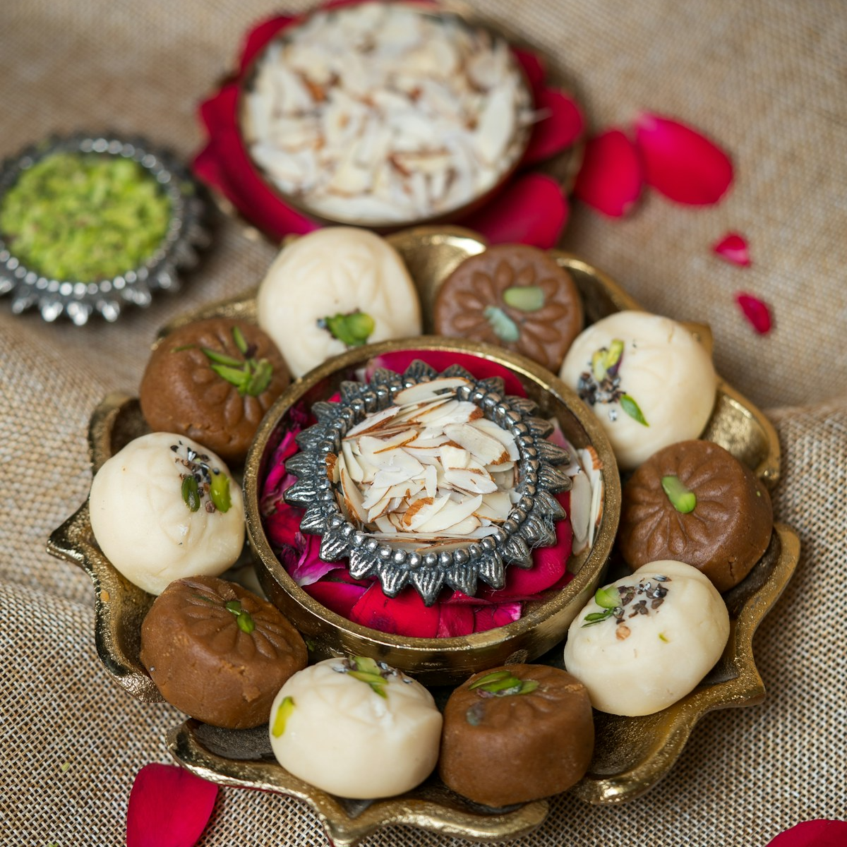A brass platter of Indian sweets set out for a celebration